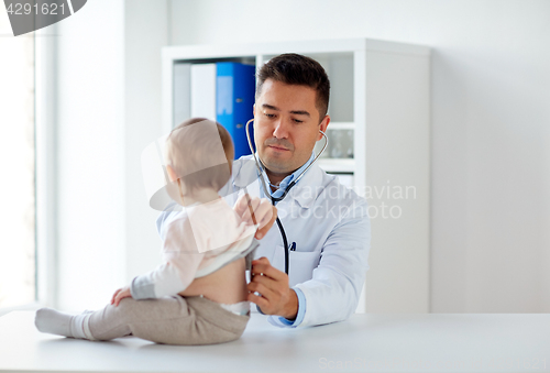 Image of doctor with stethoscope listening baby at clinic