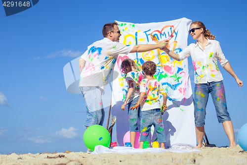 Image of Happy family playing on the beach at the day time.