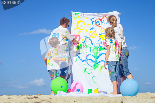 Image of Happy family playing on the beach at the day time.