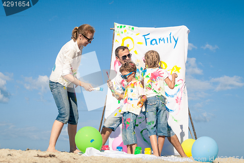 Image of Happy family playing on the beach at the day time.