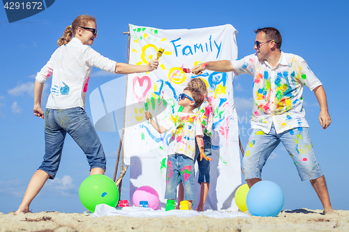 Image of Happy family playing on the beach at the day time.