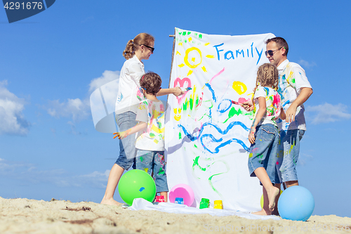 Image of Happy family playing on the beach at the day time.