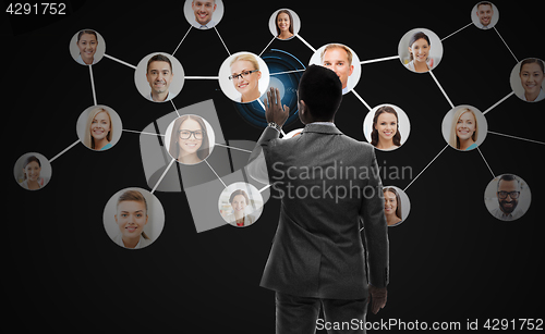 Image of businessman working with network contacts icons