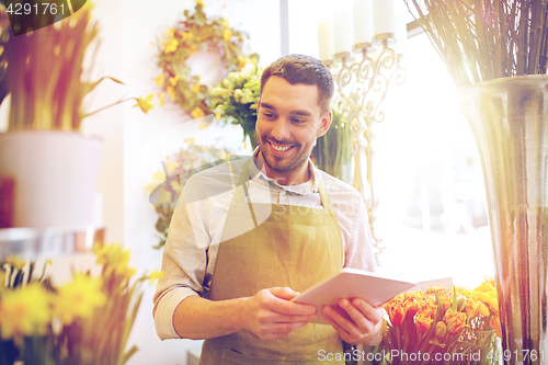 Image of man with tablet pc computer at flower shop