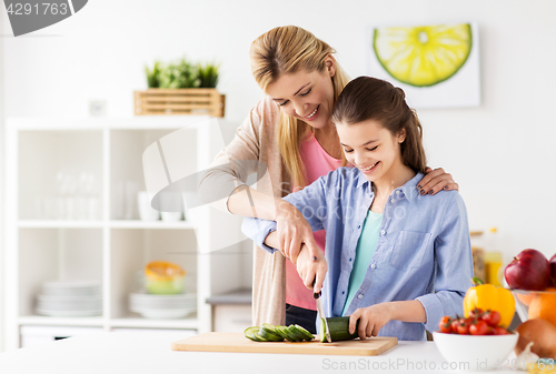 Image of happy family cooking dinner at home kitchen