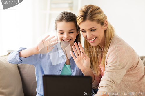Image of happy family with tablet pc at home
