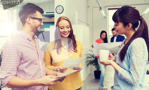 Image of creative team on coffee break talking at office