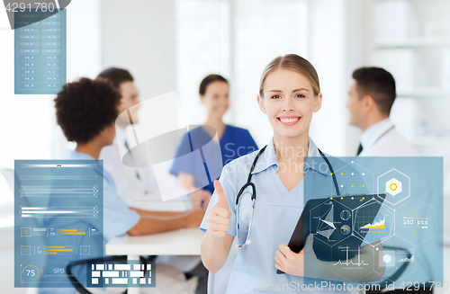 Image of happy doctor at hospital showing thumbs up gesture