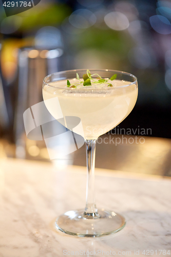 Image of glass of cocktail at bar