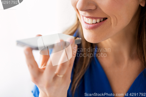 Image of woman using voice recorder on smartphone
