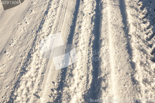 Image of traces of the car on snow