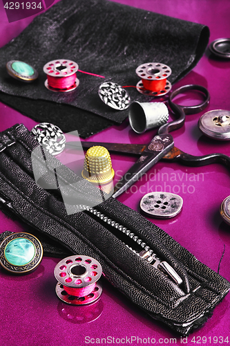Image of Sewing accessories on purple background