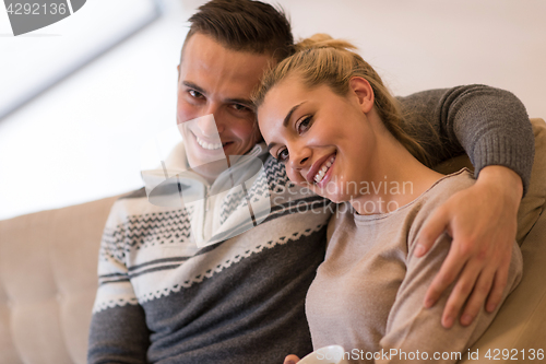 Image of Young couple  in front of fireplace