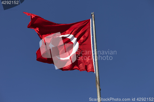 Image of Sunlight Turkish flag waving in wind at sunny day