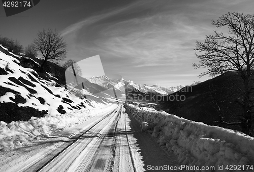 Image of Black and white view on snow road in winter morning mountain