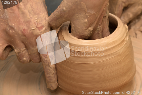 Image of Process of making clayware on potter\'s wheel