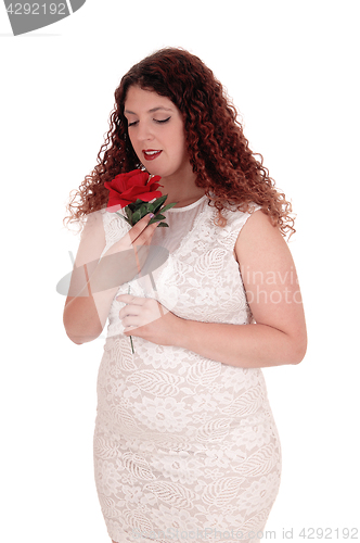 Image of Woman in white dress and rose.