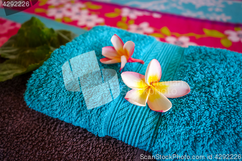 Image of White tiare flowers on a towel