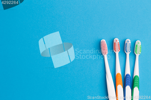 Image of Colorful toothbrushes on blue background