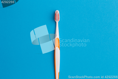 Image of Photo of one orange toothbrush