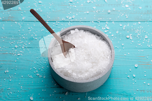 Image of sea salt on wooden background