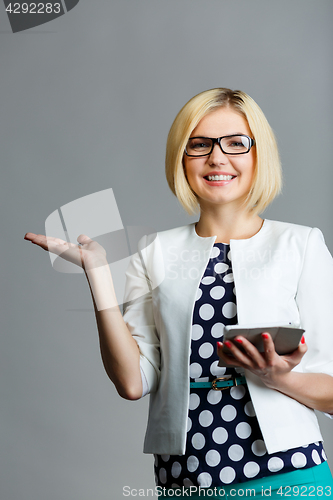 Image of Woman with smartphone holds palm