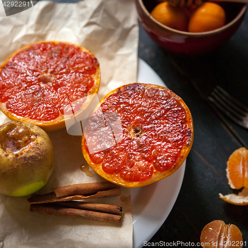 Image of Baked apples and grapefruit at wooden table