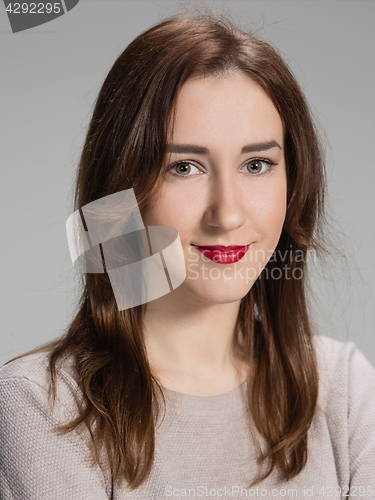 Image of The happy woman on gray background