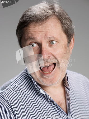 Image of Handsome pensive surprised mature businessman