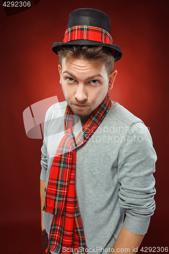 Image of The young man in cap at studio