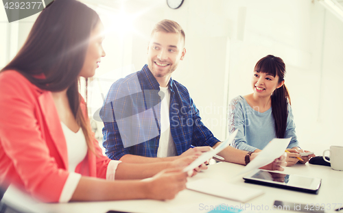 Image of happy creative team or students working at office