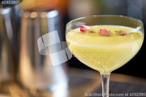 Image of close up of glass with cocktail at bar