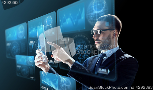 Image of businessman with tablet pc and virtual screens