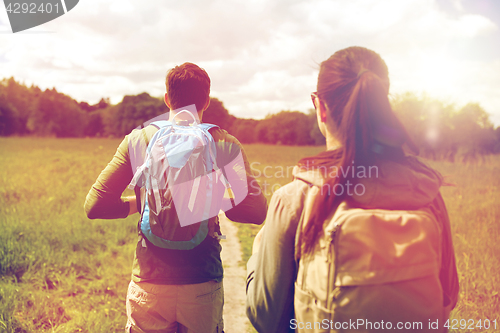 Image of close up of couple with backpacks hiking outdoors