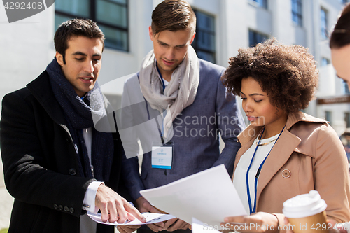 Image of international business team with papers in city