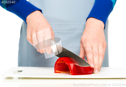 Image of Cook is chopping bell pepper