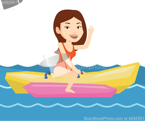 Image of Tourists riding a banana boat vector illustration.