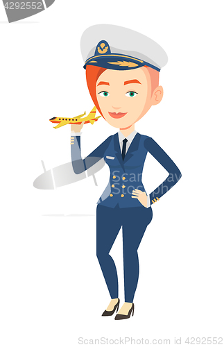 Image of Cheerful airline pilot with model airplane.