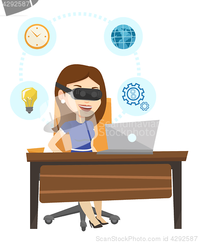 Image of Business woman in vr headset working on computer.
