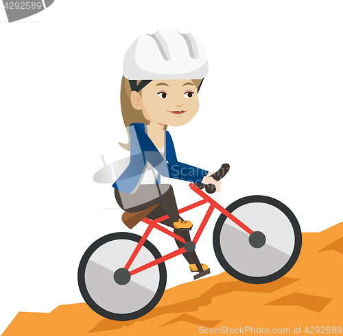 Image of Young woman on bicycle traveling in the mountains.