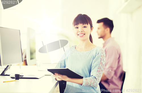 Image of happy creative female office worker with tablet pc