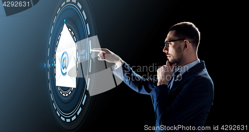 Image of businessman with e-mail message hologram