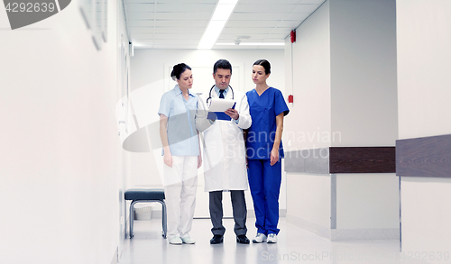 Image of group of medics at hospital with clipboard
