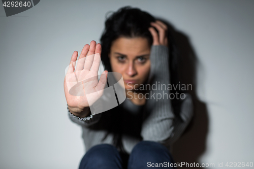 Image of unhappy crying woman showing defensive gesture