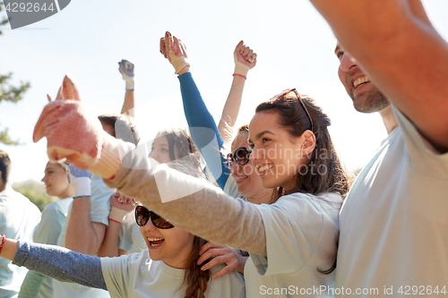 Image of group of volunteers celebrating success in park