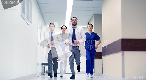 Image of group of medics walking along hospital