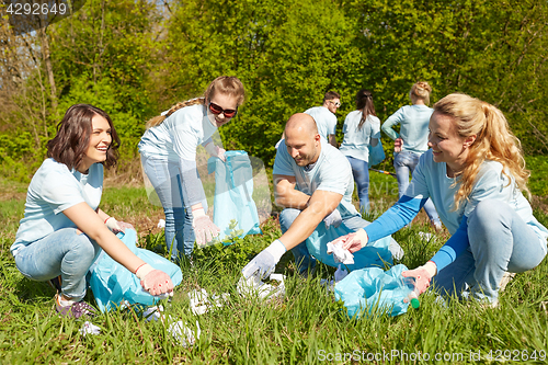 Image of volunteers with garbage bags cleaning park area