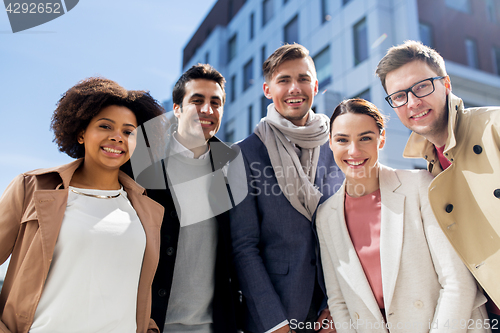 Image of group of happy people or friends on city street