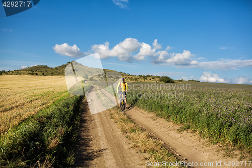 Image of Man in helmet and glasses stay on the bicycle