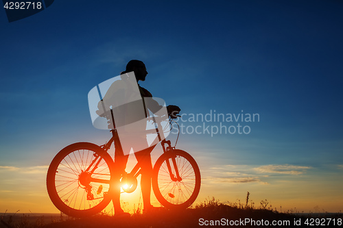 Image of Silhouette of a bike on sky background